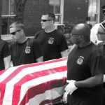 Honor guard members carrying a casket