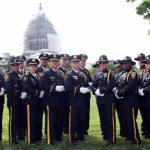 Honor Guard posing for a photo in front of the capital building