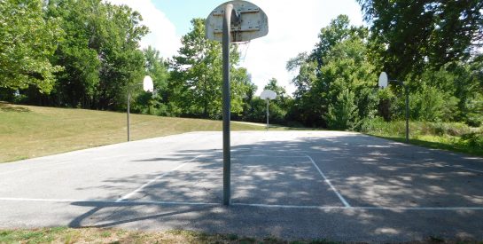 Valleyview Park Basketball Court partially shaded by trees.