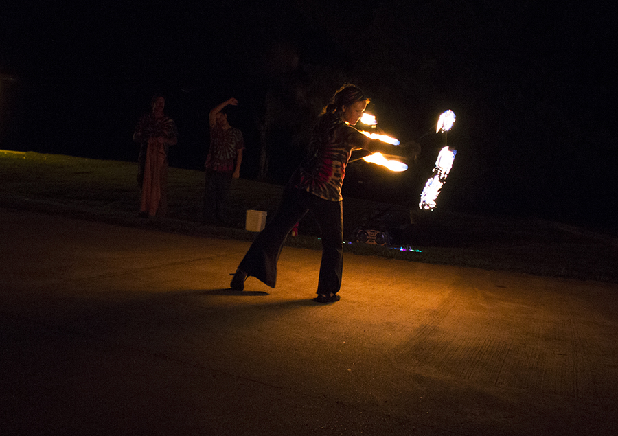 Person juggling fire at night