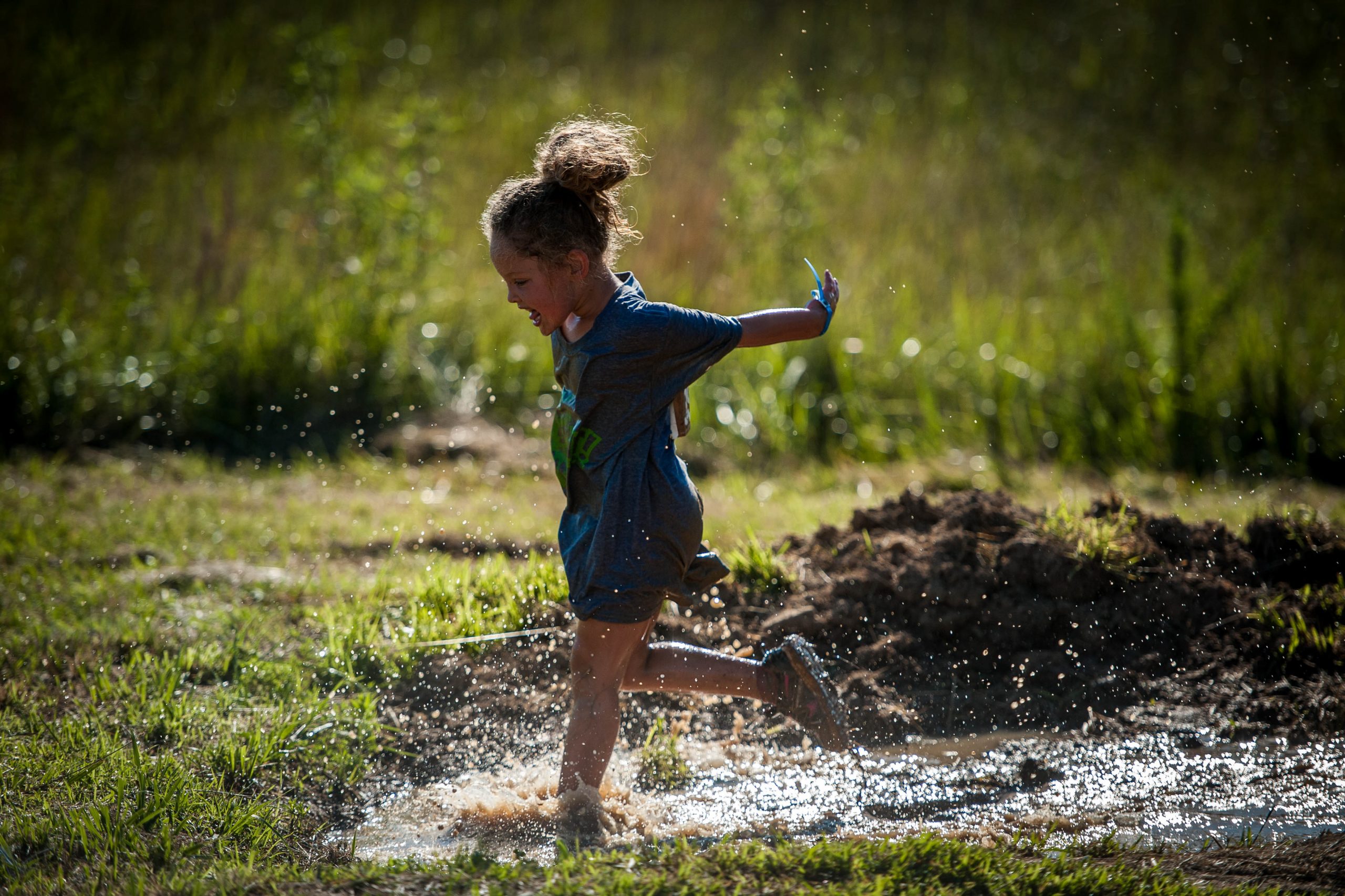 Splat: Young girl running mud.