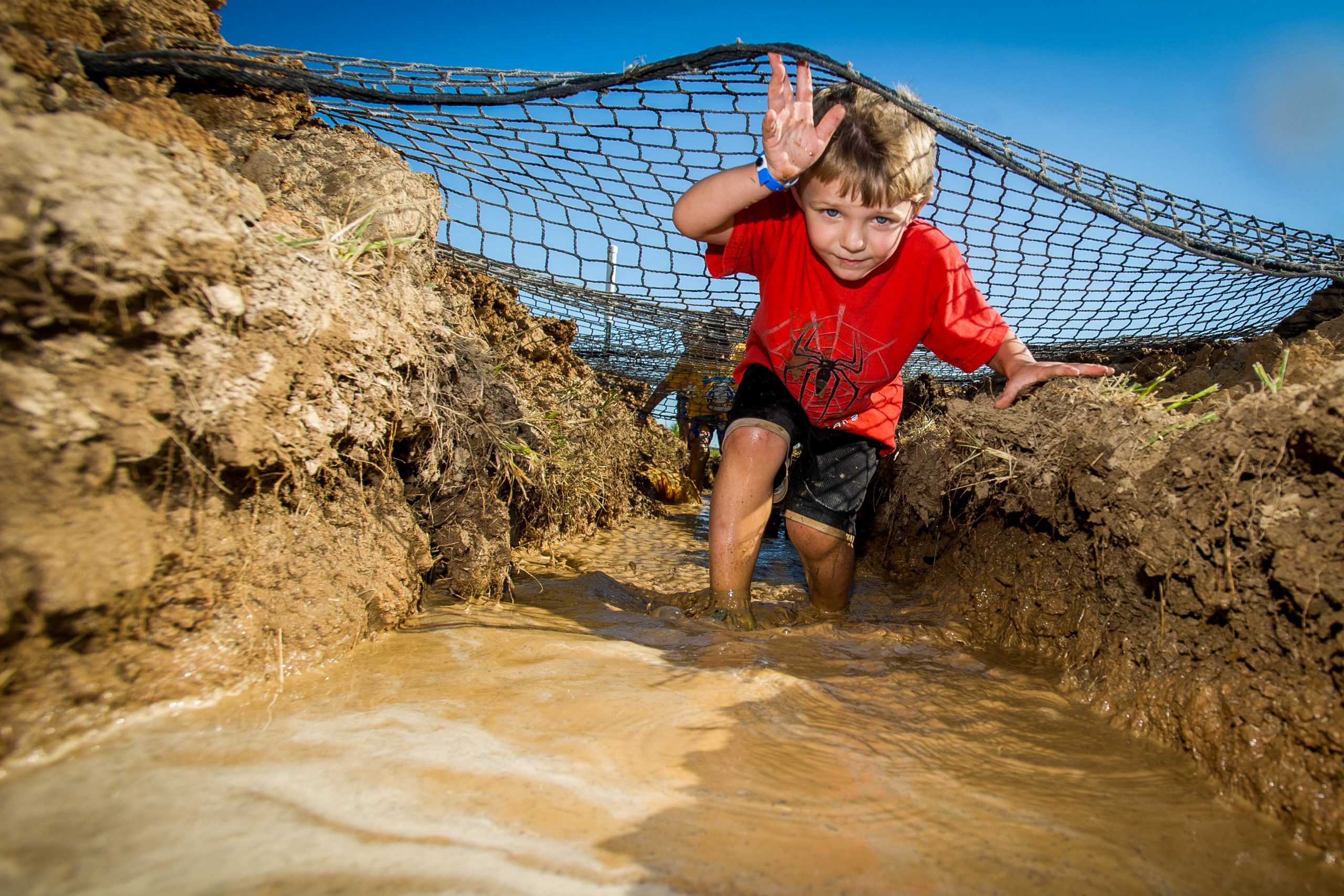 Splat: Boy in red shirt navigating the net obstacle.