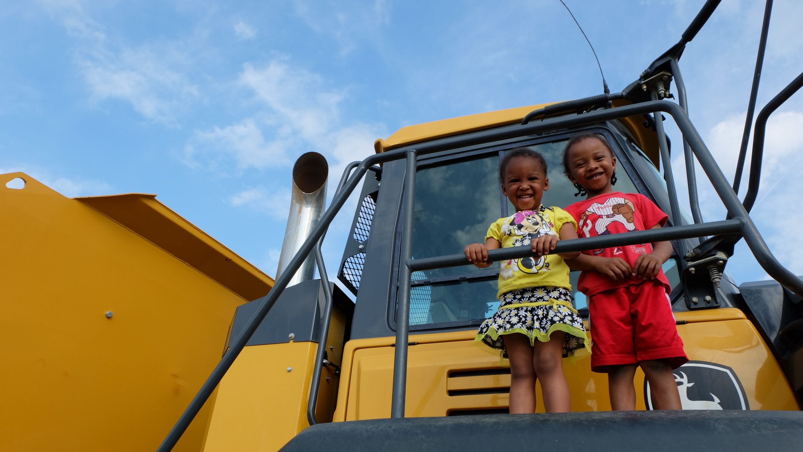 Children posing for a picture on a truck