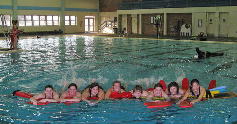 Students swimming in Hickman High School Pool