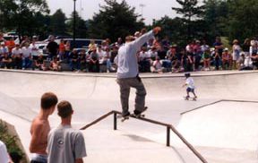 Professional skater taking on a railing at the Skate Park dedication ceremony.