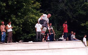 Professional skater launching off at the Skate Park dedication ceremony.