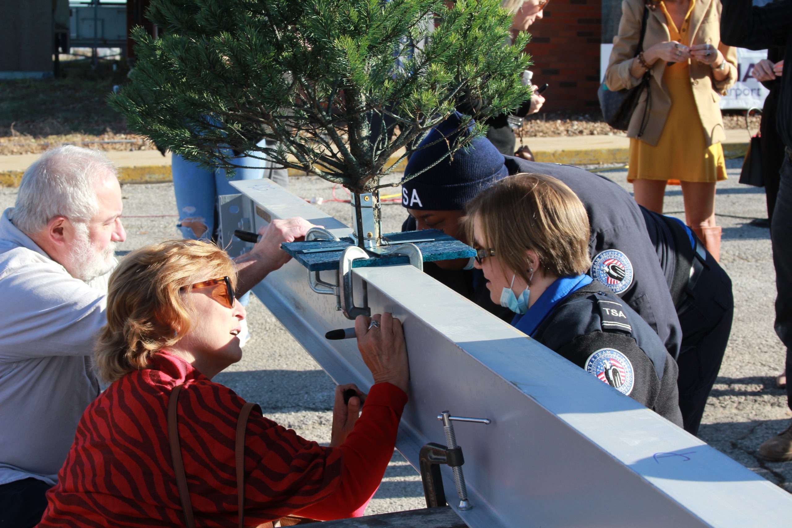 Guests signing the beam at the COU beam signing ceremony