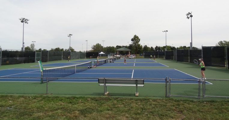 Players competing at the Cosmo-Bethel Tennis Courts.