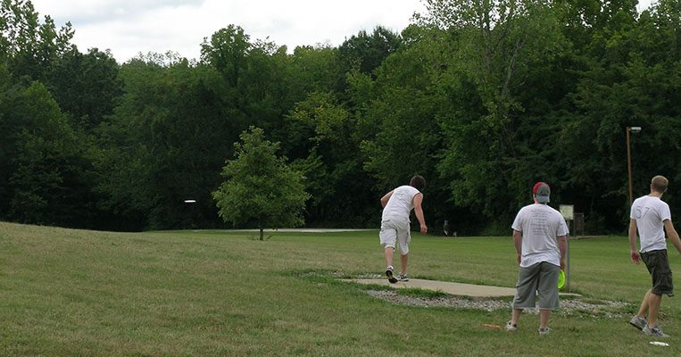 Several people playing Disk Golf