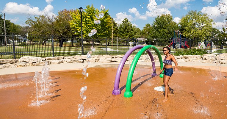 Young woman cooling off at the Douglass Spraygrounds.