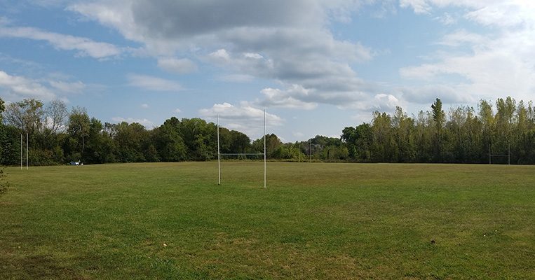 MKT Trail, Scott Boulevard Access Rugby Field with clouds overhead.